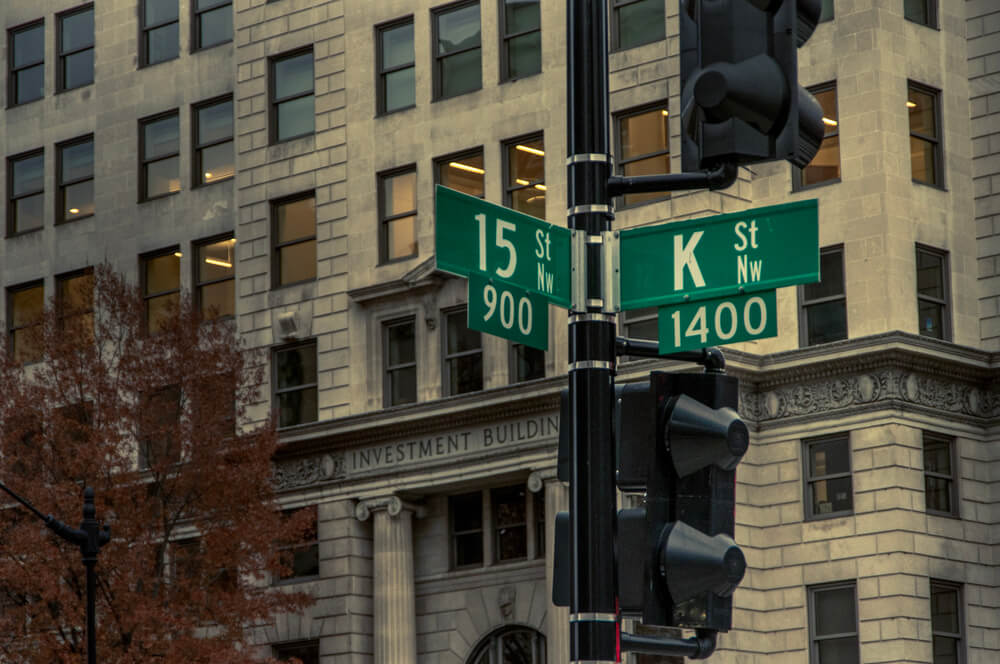 traffic light pole displays road signs at intersection of K and 15th streets. K street is the famous home of many lobbying firms in the United States capital.