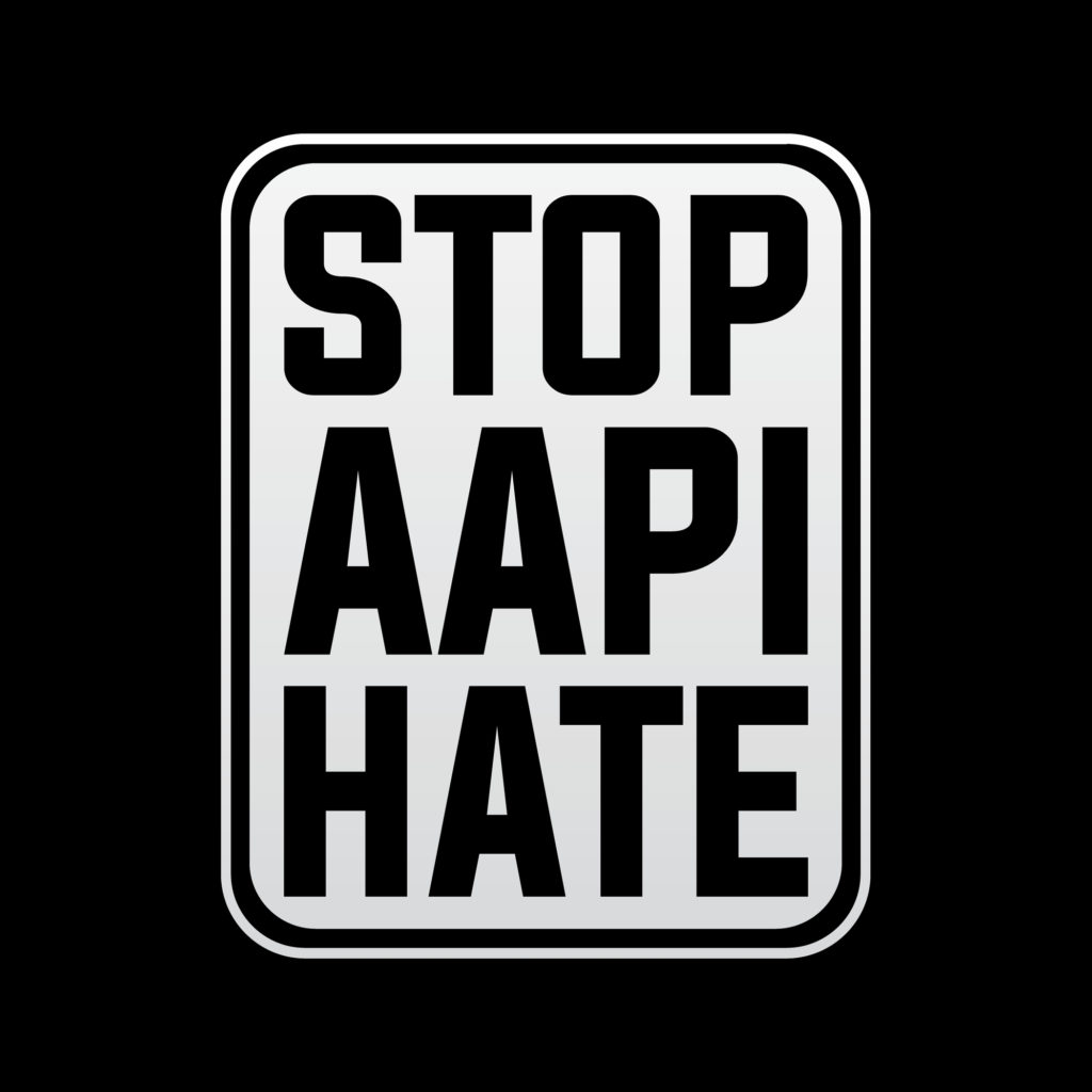 white sign on a black background reading "STOP AAPI HATE"